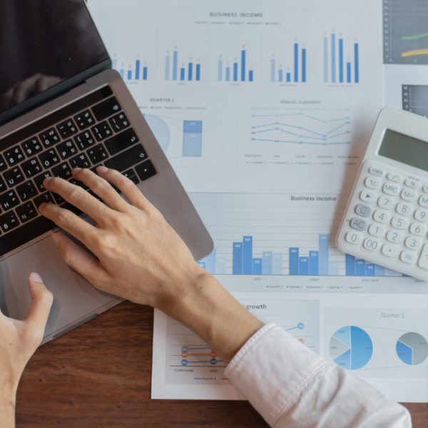 A male marketer is preparing digital marketing for finance companies on his laptop.