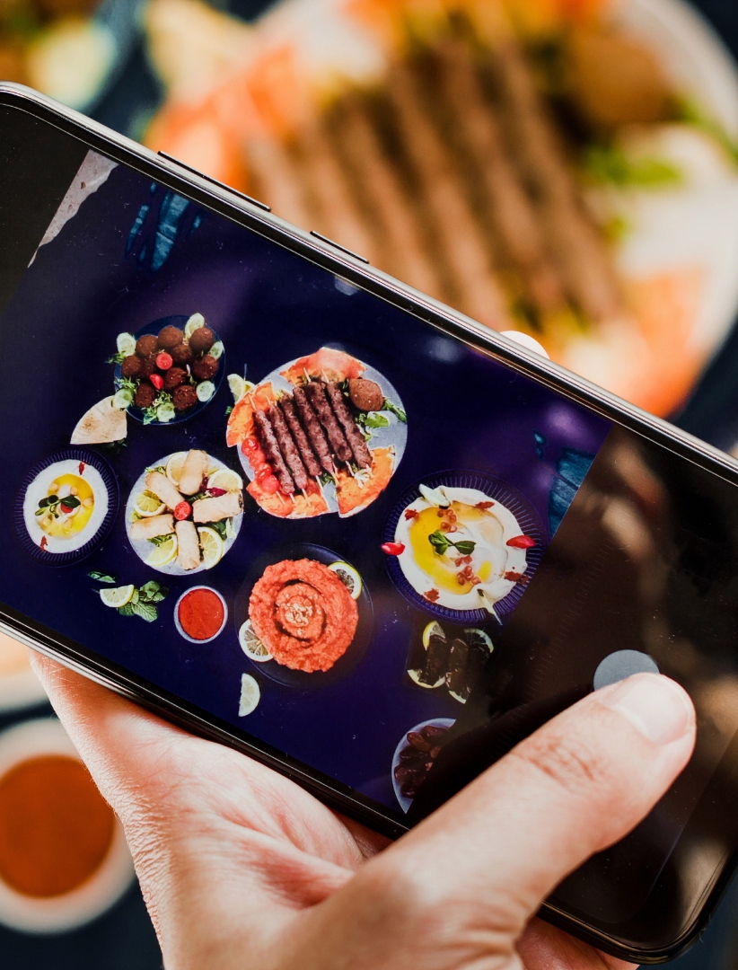someone finger take a picture of foods as a part of social media checklist for restaurant