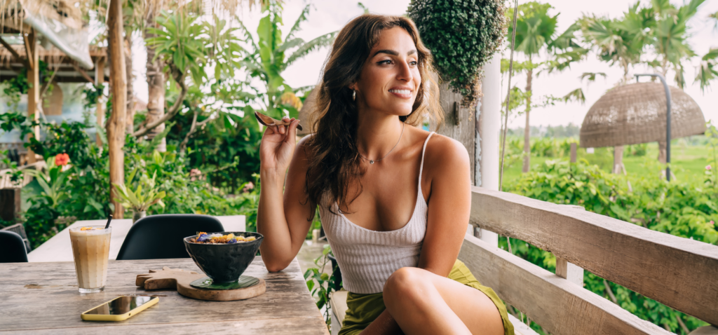 A female guest enjoying smoothies bowl